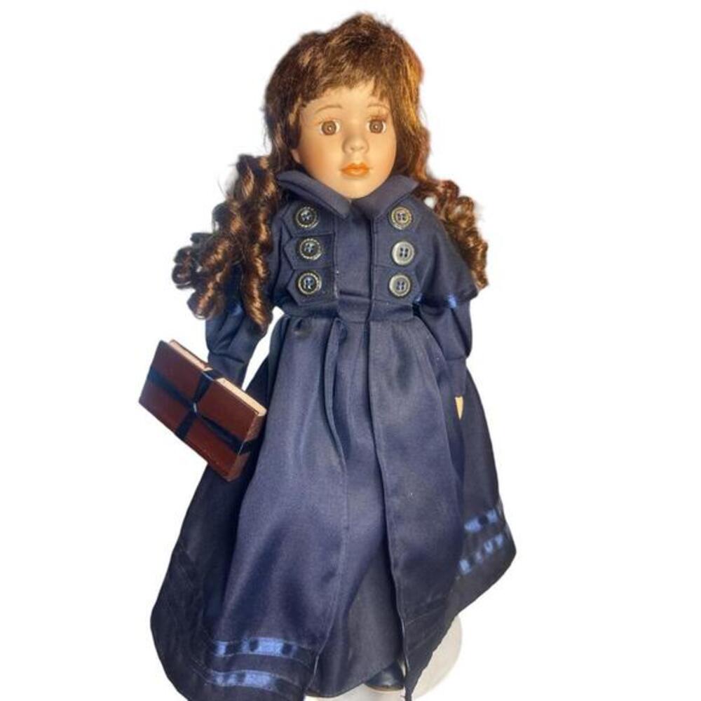 16"  Porcelain Doll. In good condition. Brown eyed, brown long hair with played